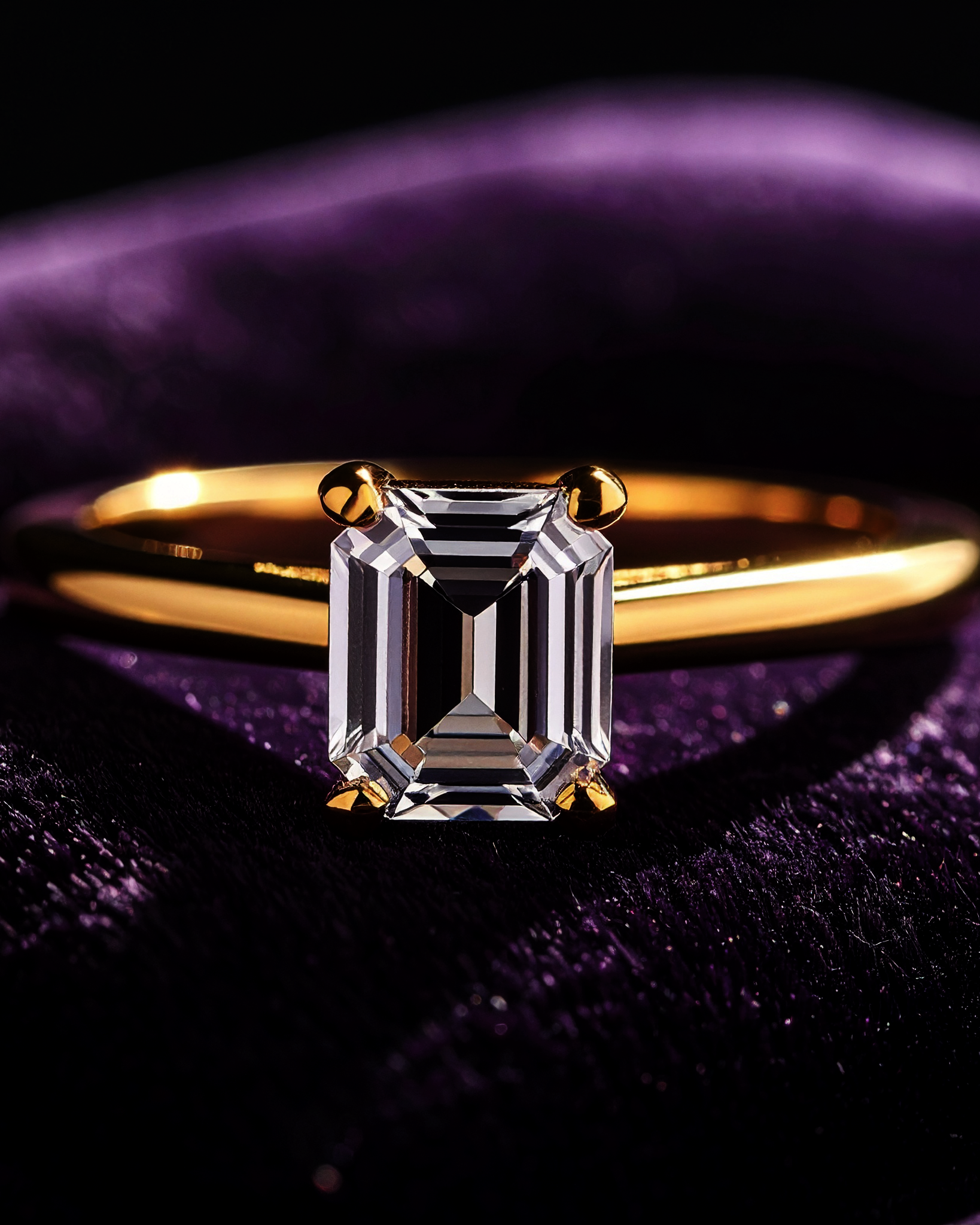Emerald-cut solitaire ring on midnight velvet